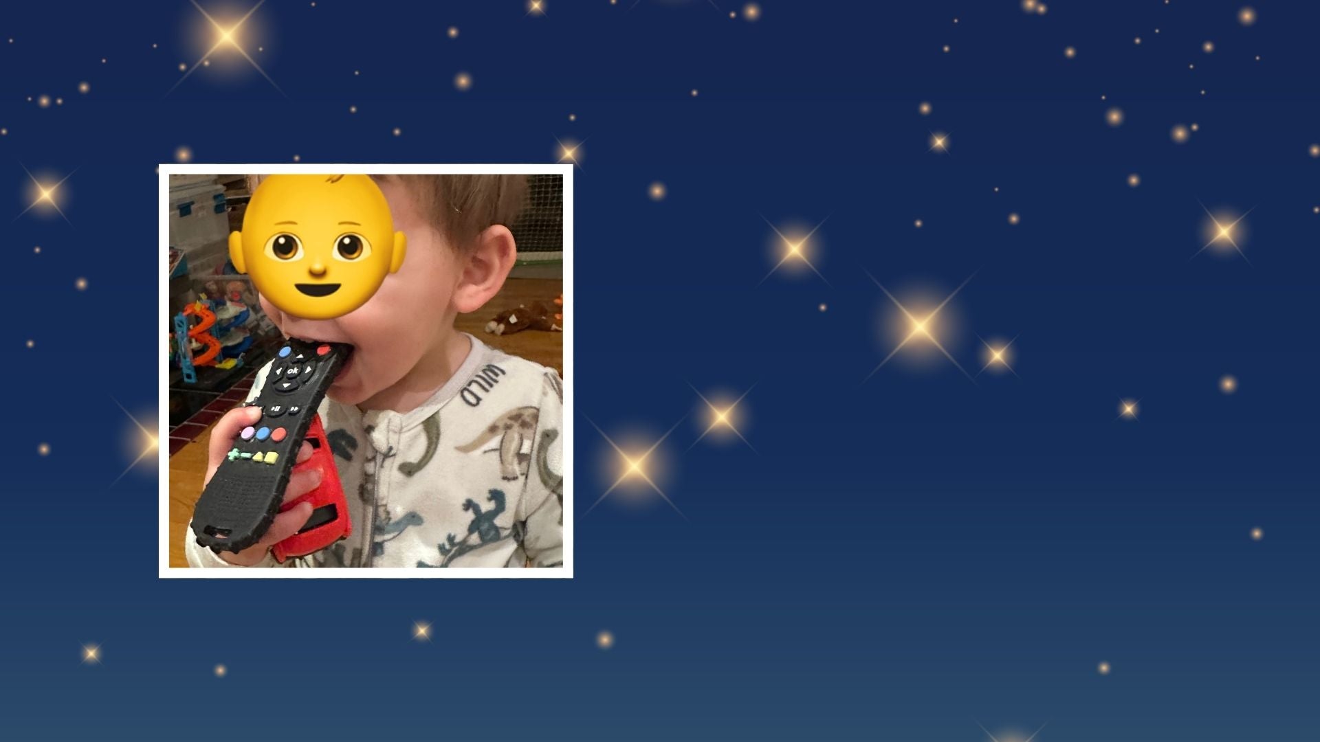 Toddler boy with a baby emoji covering his face for anonymity, chewing on a remote control teether